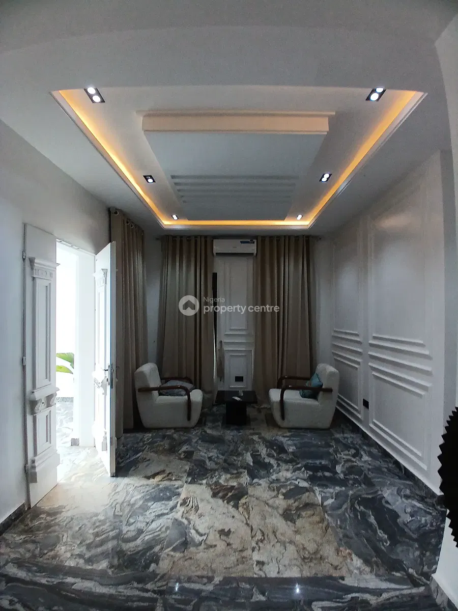 Small sitting area with two chairs and illuminated ceiling detail