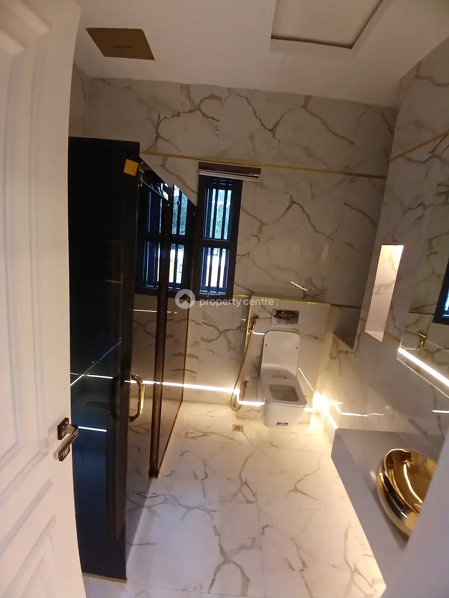 Bathroom with glass shower enclosure and warm lighting