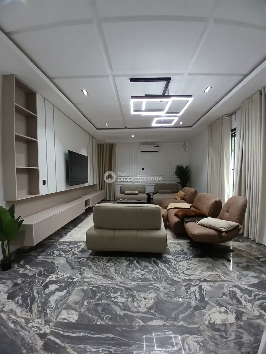 Family lounge with seating, television wall and geometric ceiling lights