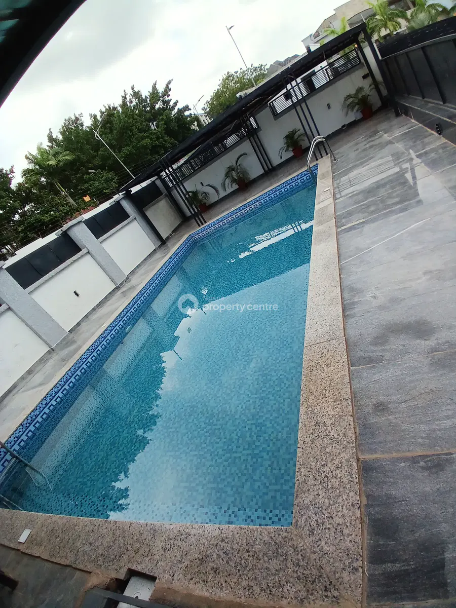 Swimming pool and paved terrace within the residence grounds