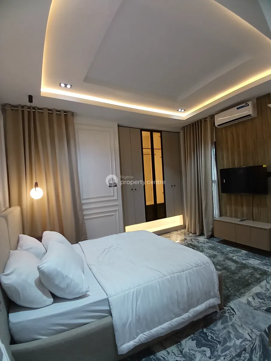 Bedroom with white bedding and timber wall finish