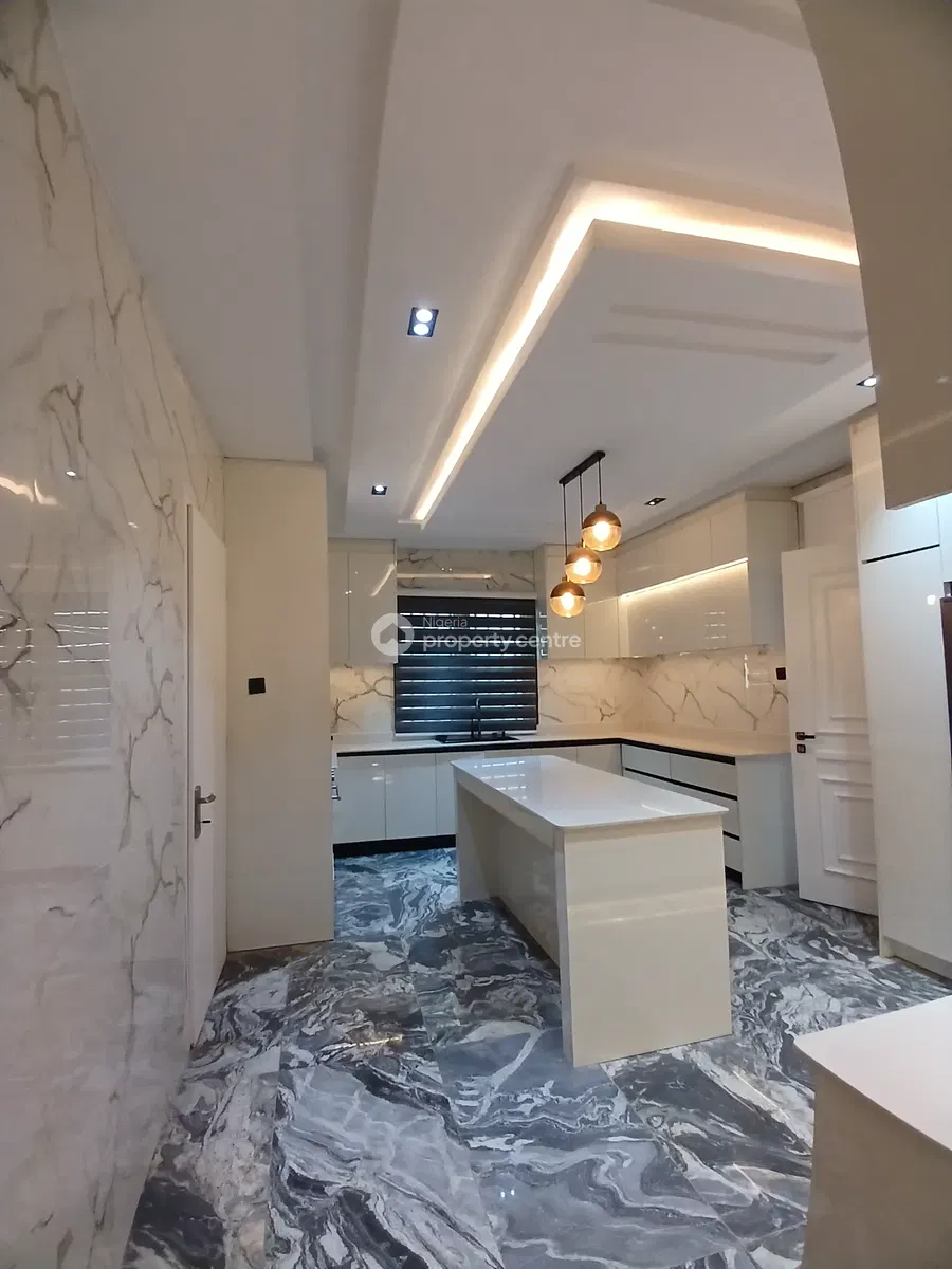 Bright fitted kitchen with central island and marble-patterned floor