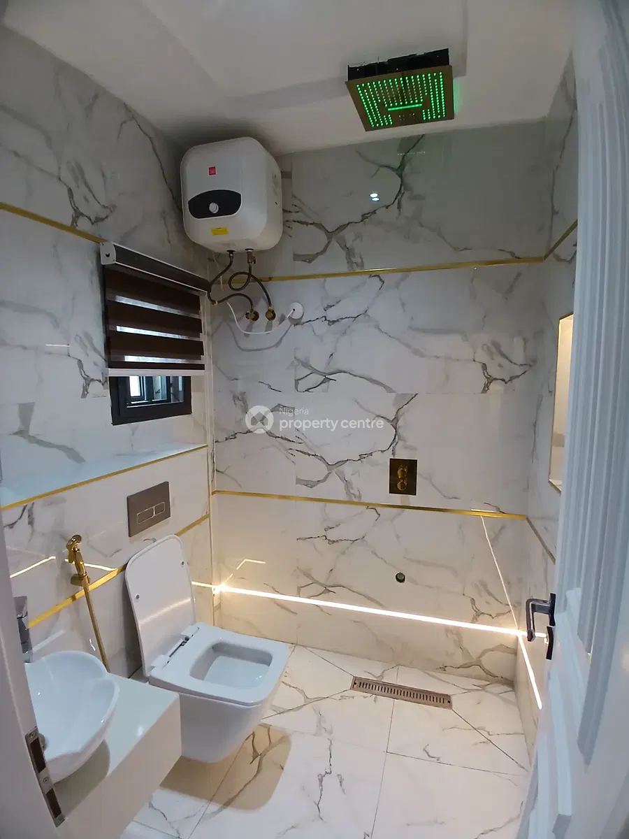 Bathroom with marble-patterned walls and green showerhead