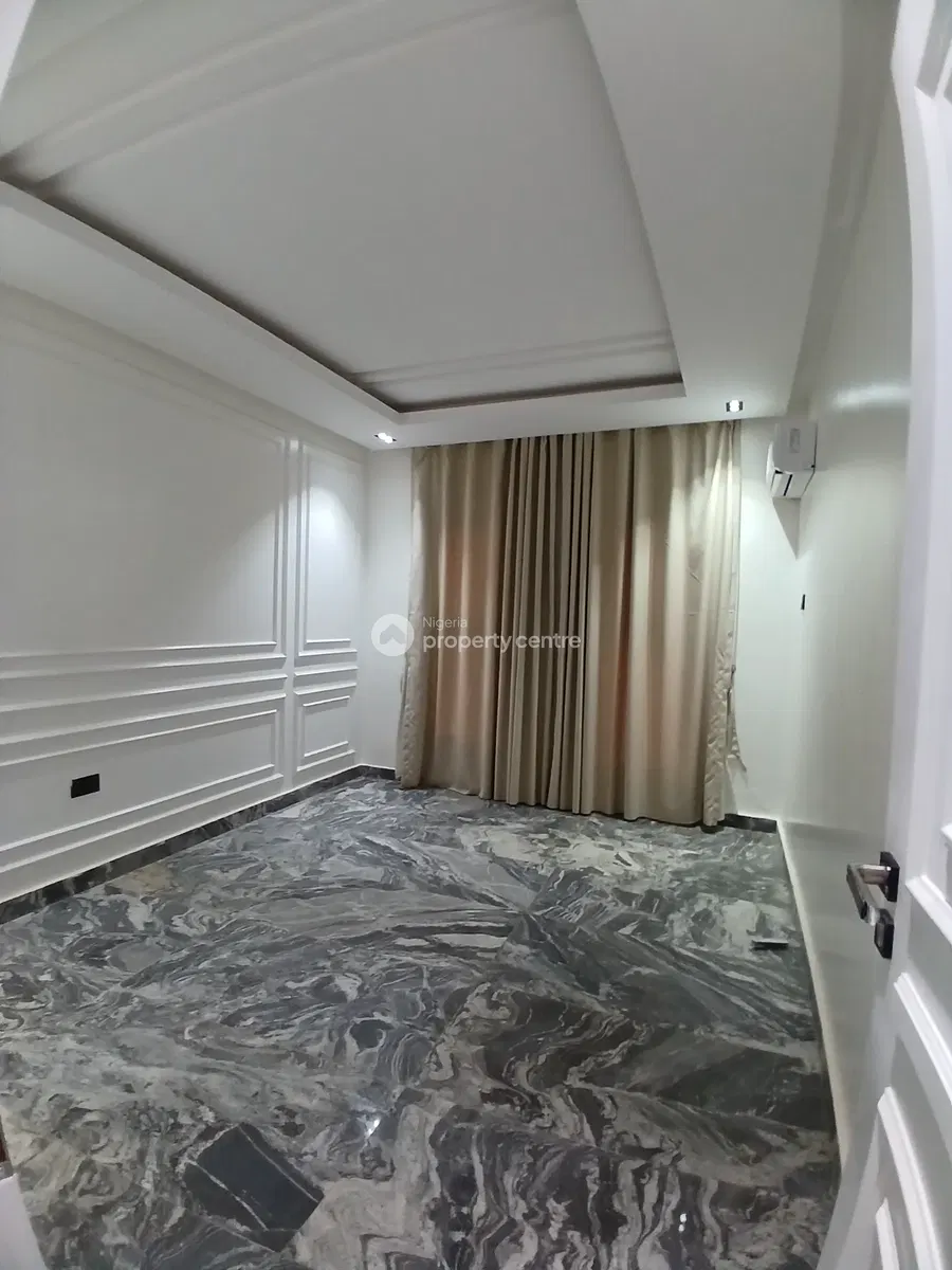Unfurnished room with marble-patterned floor and curtains